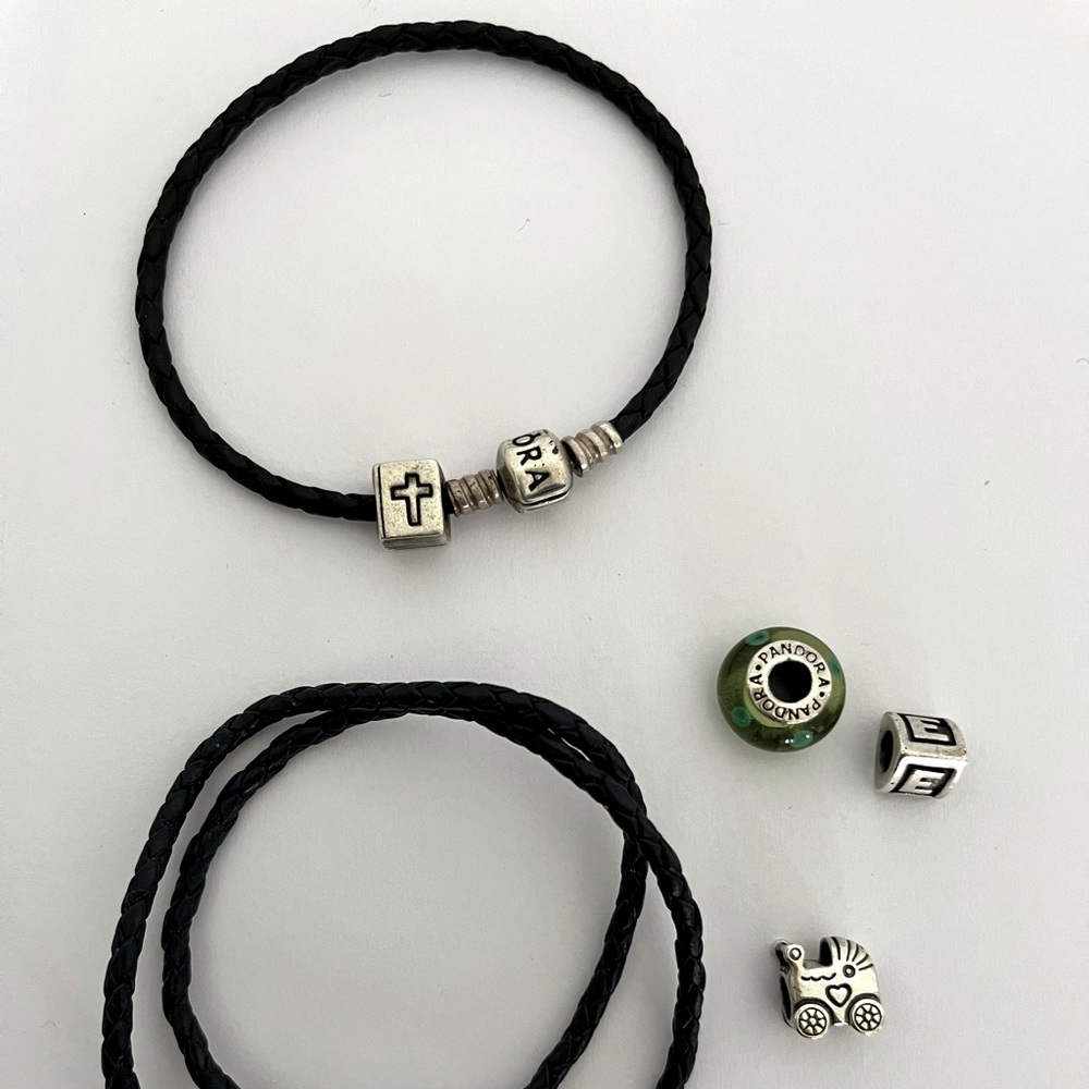 Original Pandora bracelets. One is double. Color black both with four charms.